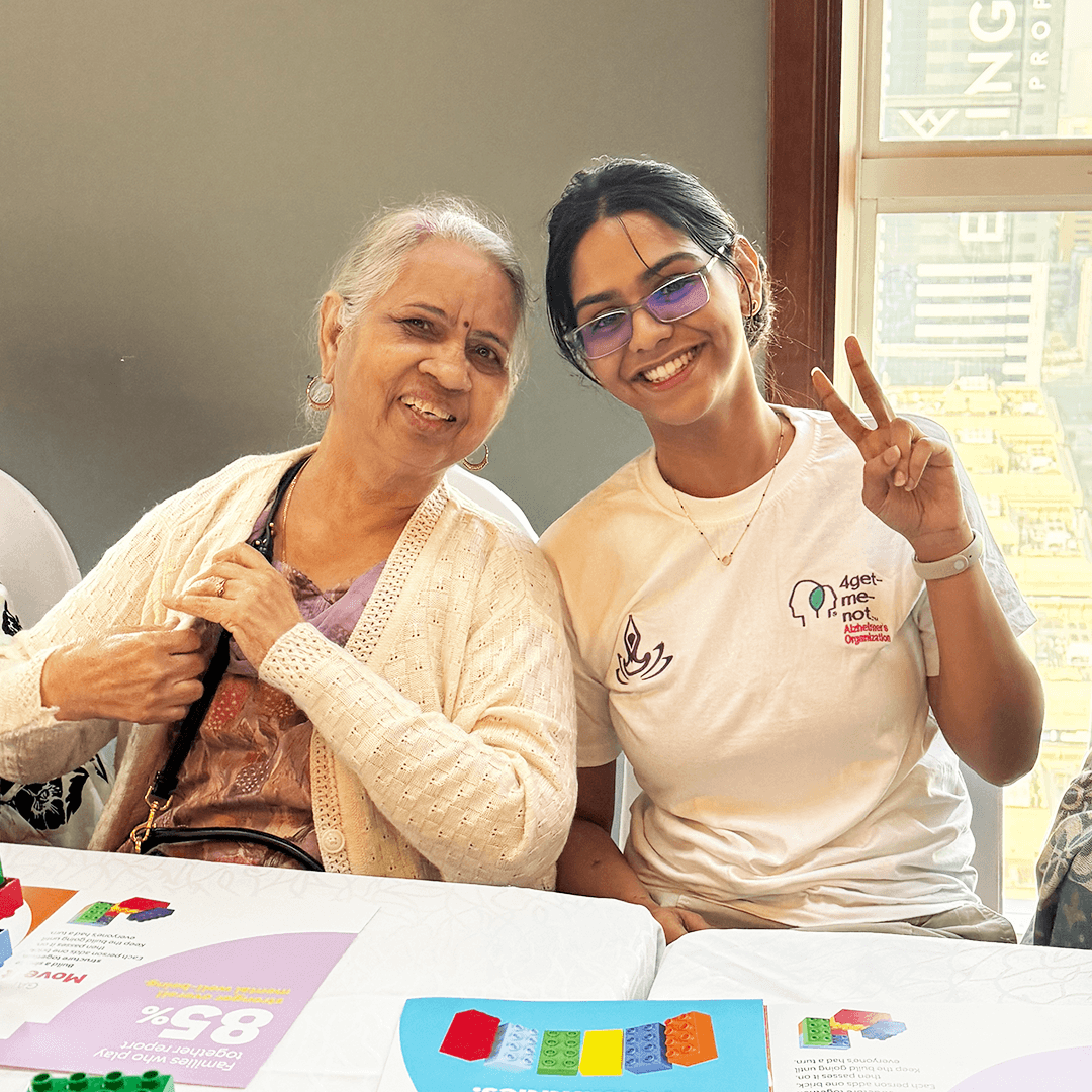 Close-up of a senior citizen teaching a student how to sew a button, highlighting intergenerational learning and connection.