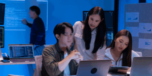 IT professionals analysing advanced neural networks and cybersecurity threat data in a high-tech lab