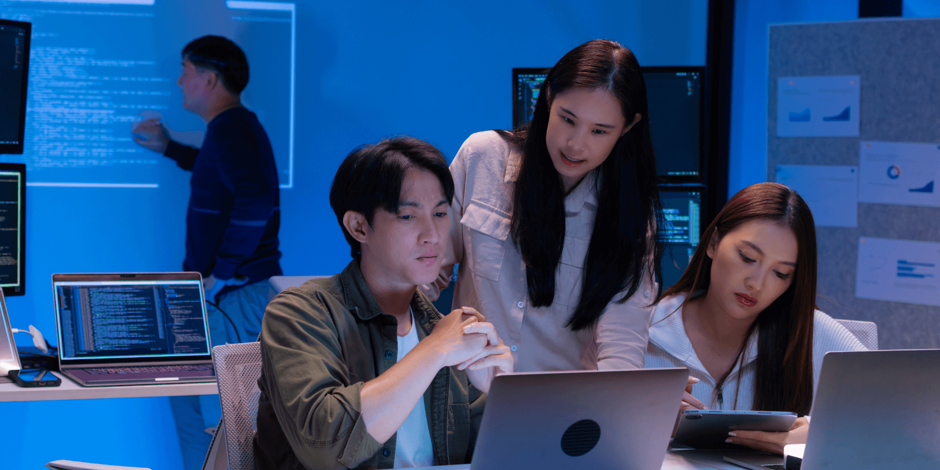 IT professionals analysing advanced neural networks and cybersecurity threat data in a high-tech lab