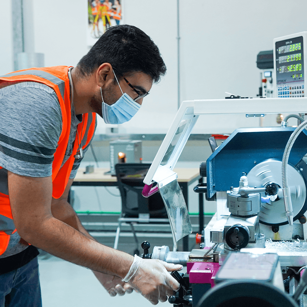 Curtin University Dubai Mechanical Engineering student using manufacturing equipment as part of practical engineering learning