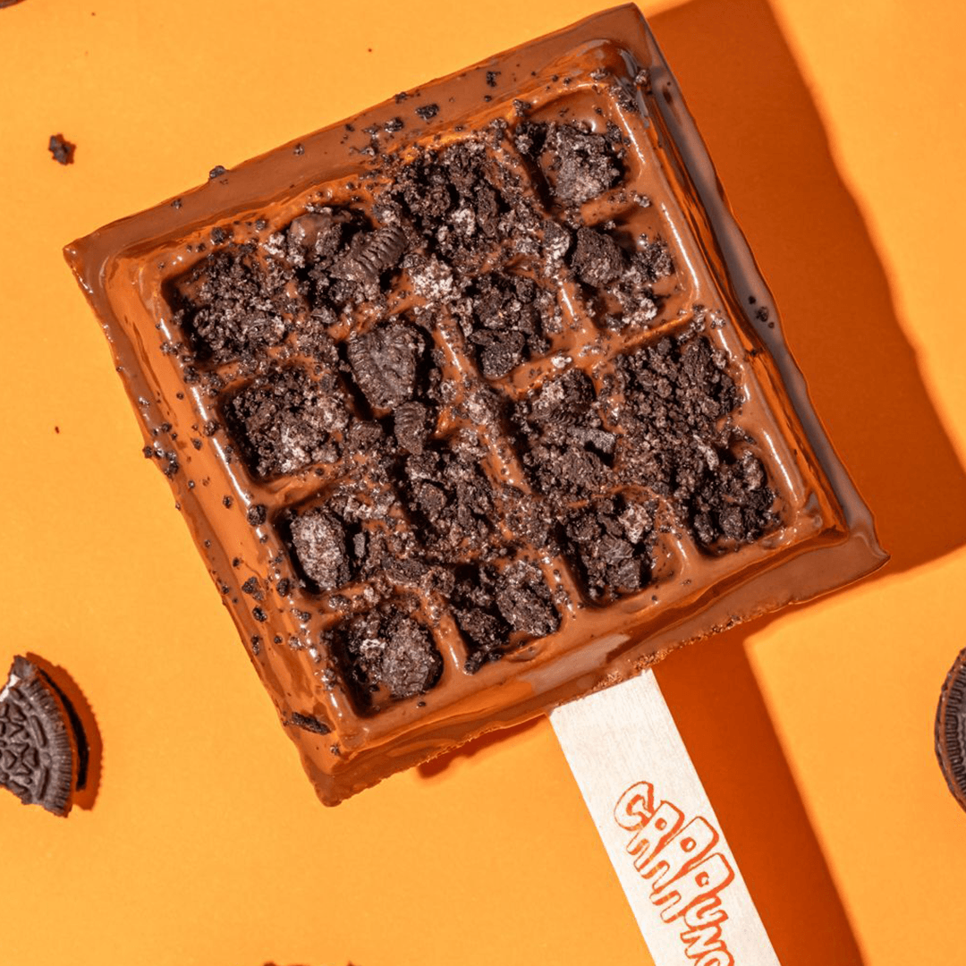 A bestselling chocolate-covered waffle pop topped with crushed chocolate cookies, developed by the Crrrunch team.