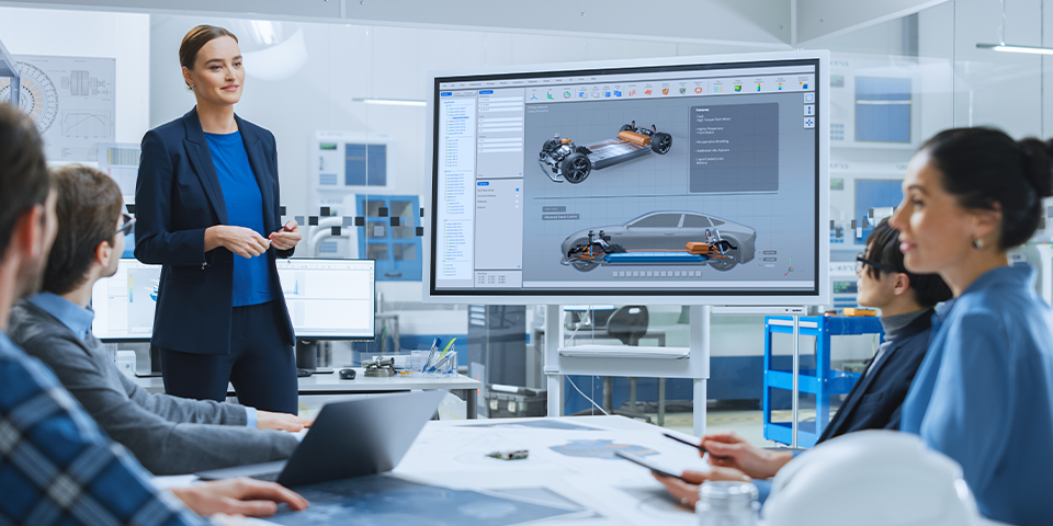 Engineering manager presenting an automotive design to a multidisciplinary team, reflecting the leadership and project management skills developed through a Curti Dubai's Master of Engineering Management.